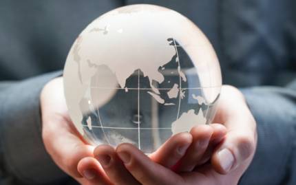 someone holding a glass globe